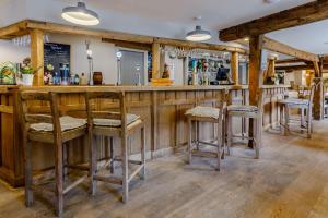 a bar with stools in a room at The Grousemoor - North Wales luxury 7 bedroom holiday rental in Llandegla