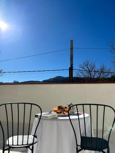 two chairs and a table on a patio at Bicis & Vacas in La Pola de Gordón