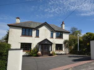 a large white house with a driveway at 3 Bed in Dulverton RDOOR in Exton