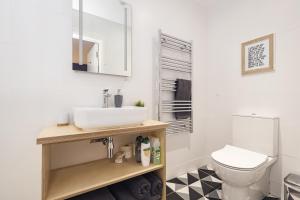 a bathroom with a sink and a toilet at Port 56 in Portstewart