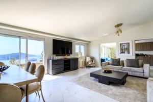a living room with a couch and a table at VILLA BELLE VUE VI4394 By Riviera Holiday Homes in Villefranche-sur-Mer