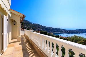 a balcony with a view of the water at VILLA BELLE VUE VI4394 By Riviera Holiday Homes in Villefranche-sur-Mer