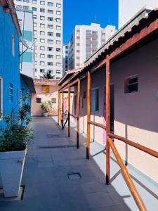 a walkway in a city with buildings in the background at Pousada Villa Brasil Ocian in Praia Grande