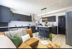 The Residency rooms Liverpool في ولاسي: غرفة معيشة مع أريكة ومطبخ