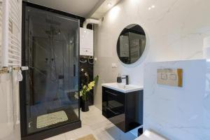 a bathroom with a shower and a sink at Lux Apartment in Rzeszów +14 photos