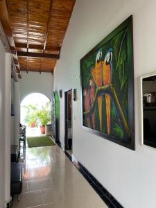 a hallway with a painting on the wall at HOTEL VILLA DANIELA in Puerto Triunfo