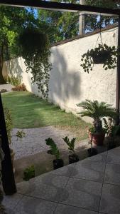 a patio with potted plants and a wall at Casa Temporada in Rio de Janeiro