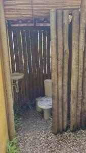 a toilet sitting inside of a wooden fence at Casa Temporada in Rio de Janeiro