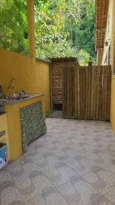a patio with a sink and a wooden fence at Casa Temporada in Rio de Janeiro