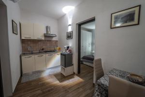 a small kitchen with a sink and a refrigerator at Casa Iraci La Nostra Sicilia in Trapani