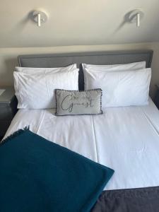 a white bed with a pillow on top of it at Most Easterly - The Loft in Pakefield