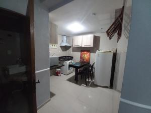 a kitchen with a refrigerator and a table in it at Hotel Palace in Porto Alegre