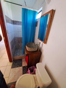 a bathroom with a sink and a toilet and a shower at CASA FOTR LOCO in Uvita