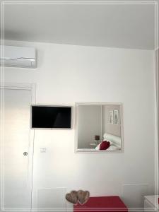 a living room with a tv on a white wall at Medico Romantic House in Monopoli +9 photos