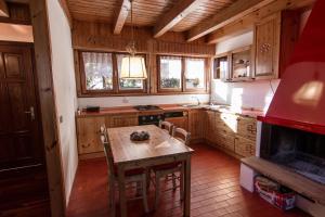 a kitchen with wooden cabinets and a table and a stove at App Carolina in Creazzo +9 photos