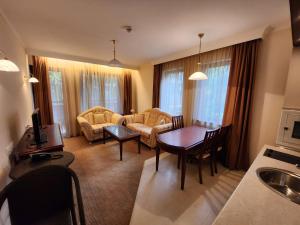 a living room with a couch and a table at Luxury Downtown Appartment - 150m ski lift Gondola in Bansko