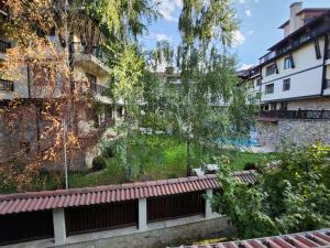 a park bench in front of a building at Luxury Downtown Appartment - 150m ski lift Gondola in Bansko