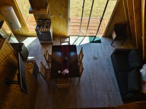 an overhead view of a living room with a table and chairs at Travesía Rukamanque Lodge in Temuco