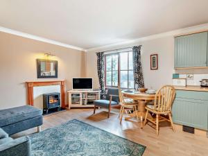 a kitchen and living room with a table and chairs at 1 Bed in Callander 45288 in Saint Fillans