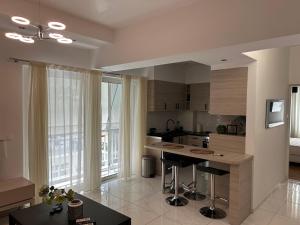 a kitchen with a island in the middle of a room at Athens Acropolis cozy apartment in Athens