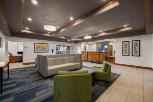 a lobby with a couch and chairs and a kitchen at Holiday Inn Express Hotel & Suites Limon I-70/Exit 359, an IHG Hotel in Limon