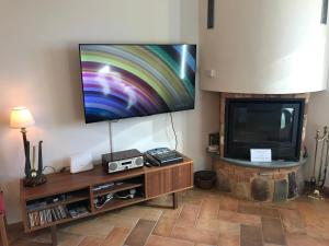 a living room with a flat screen tv on a wall at Casa con vista in Costa di Serina