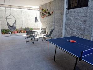 a ping pong table in a room with chairs at Suite Departamento Nuevo in Aguascalientes