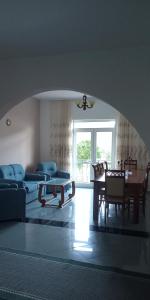 ein Wohnzimmer mit Sofas, einem Tisch und Stühlen in der Unterkunft Guest House Irvin in Berat