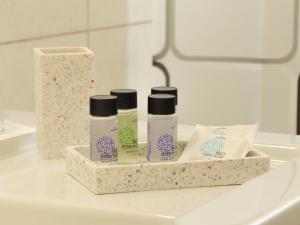 a bathroom counter with three bottles of cosmetics on it at Ixia Aqua Vista House in Rhodes Town