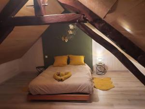 1 dormitorio con 1 cama en el ático en Gite avec spa sous les étoiles, en Erbrée