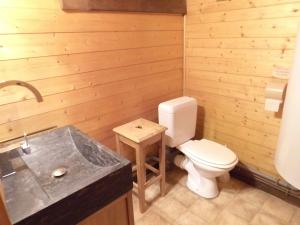 a wooden bathroom with a toilet and a sink at Le Manège Ouest in Saint-Gervais-les-Bains