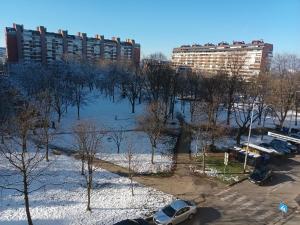 a parking lot with cars parked in front of a building at NEW - Frendly Luxury Apartment Franka Zagreb in Zagreb