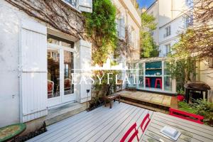 une terrasse avec un banc devant un bâtiment dans l'établissement Nice 5-bedroom apartment like a house, Boulogne, by Easyflat, à Boulogne-Billancourt