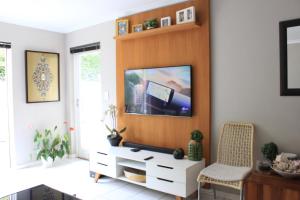 a living room with a flat screen tv on a wall at Tranquil Haven with Uninterrupted Power, a Serene Oasis in the Heart of Cape Town in Cape Town