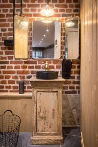 y baño con lavabo y espejo. en Le Pigeonnier, maison d'hôtes et Spa en Croix