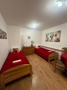 a bedroom with two beds and a red blanket at Travel House Wroclaw in Wrocław