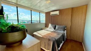 a bedroom with a bed and a potted plant at WTS HOUSE BOAT in Brasilia