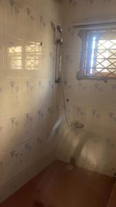 a bathroom with a shower in the corner of a room at Charming 1-Bed Apartment in Accra in New Weija