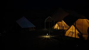a group of tents in the dark at night at La Window Glamping in La Ventana