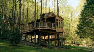 a tree house in the middle of the forest at The Magnolia in Treehouse Grove at Norton Creek in Gatlinburg