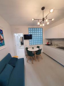 a living room and kitchen with a blue couch and a table at Da Nonno Ciccio in Valenzano