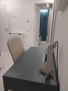 a table and a chair in a room at Da Nonno Ciccio in Valenzano