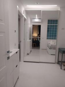 a white bathroom with a mirror and a room at Da Nonno Ciccio in Valenzano