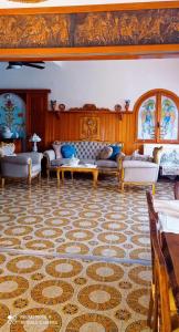 a living room with couches and a rug at Apollonion Apartment Aigina in Perdhika