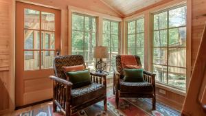 two chairs in a room with windows at The Elm in Treehouse Grove at Norton Creek in Gatlinburg +21 photos