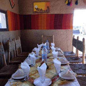 a table with plates and bottles of water on it at Camp Familia Erg Chebbi in Merzouga