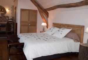 Chevagnes的住宿－LE GOÛT DES CHOSES，卧室配有一张带白色床单和枕头的大床。