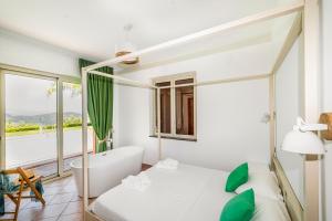 een slaapkamer met een bad, een bed en een raam bij Delightful 4 Bed Villa with Heated pool & Jacuzzi Overlooking Aeolian Islands in Castroreale