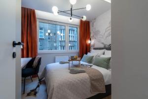 um quarto com uma cama, uma secretária e uma janela em Lucky Seven No. 2 em Poznań