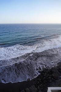 an aerial view of the ocean with waves at Playa Chica Beachfront Apartment in Santa Cruz de Tenerife